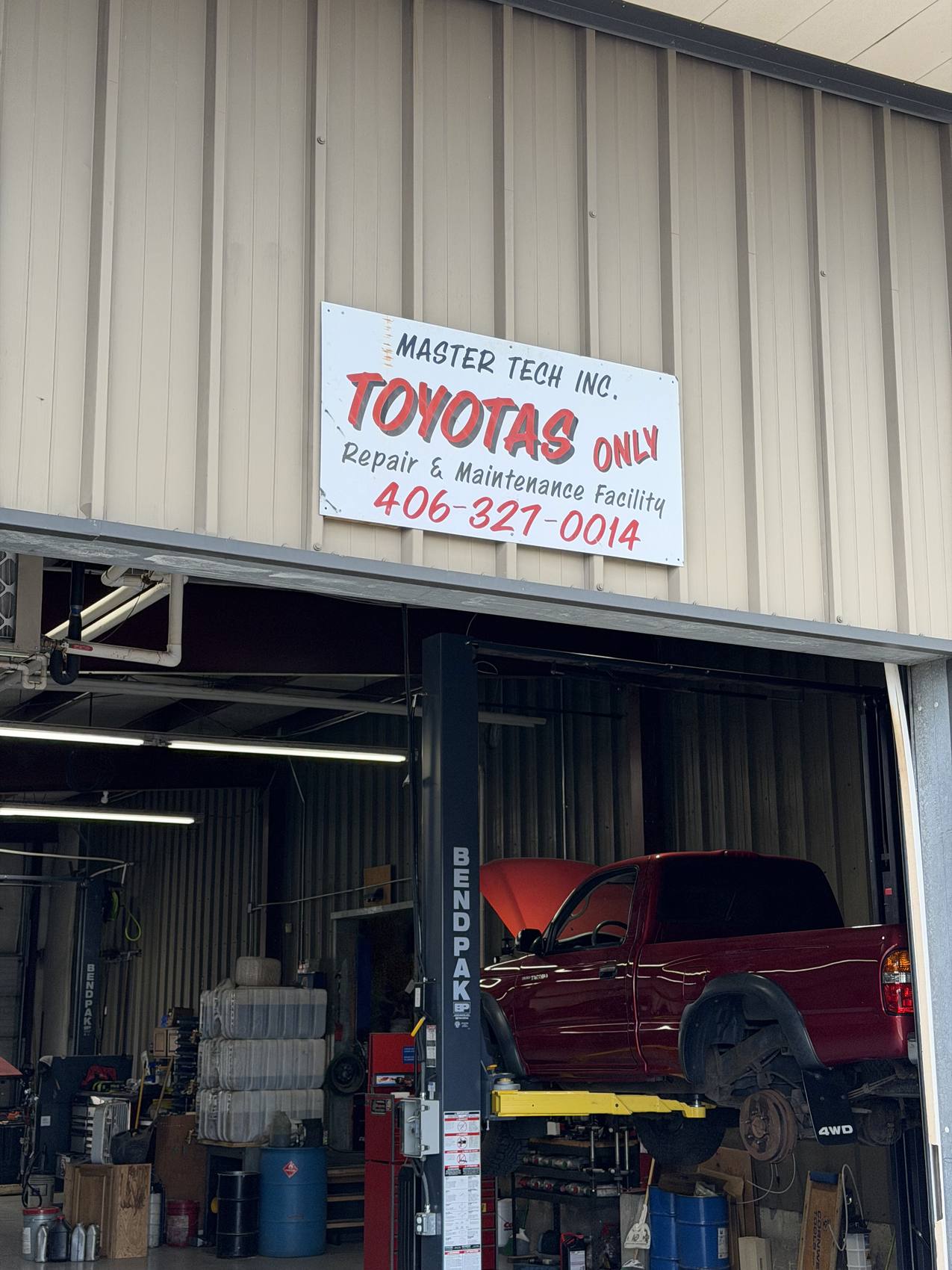 Master Technician – Toyotas Only shop in Missoula, MT, with a Toyota Tacoma on the lift